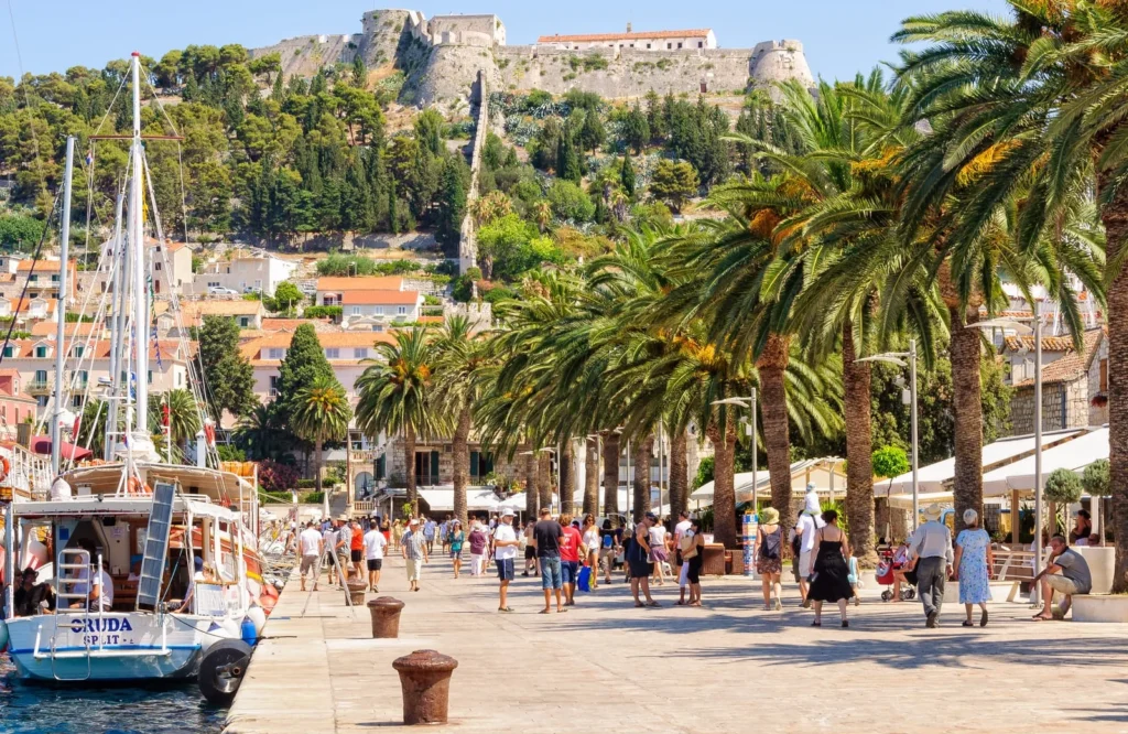 Tourists stroll in the Riva harbour