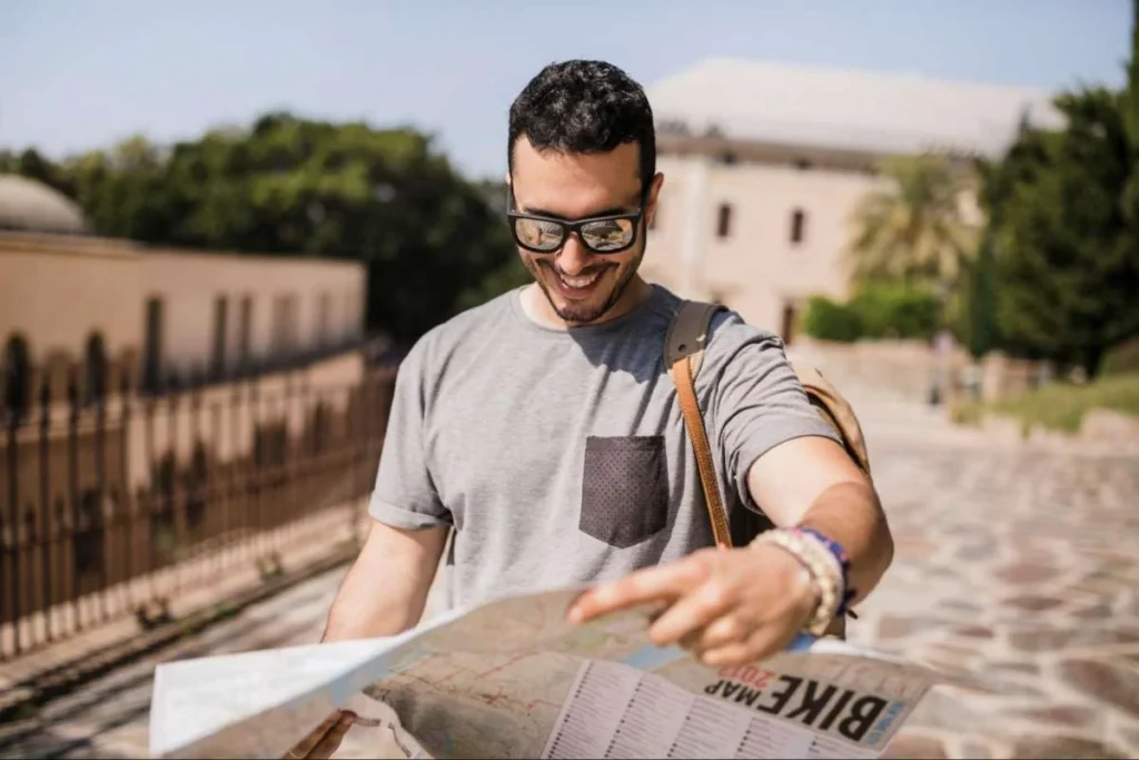 Traveler reading map while exploring peaceful rural French village street