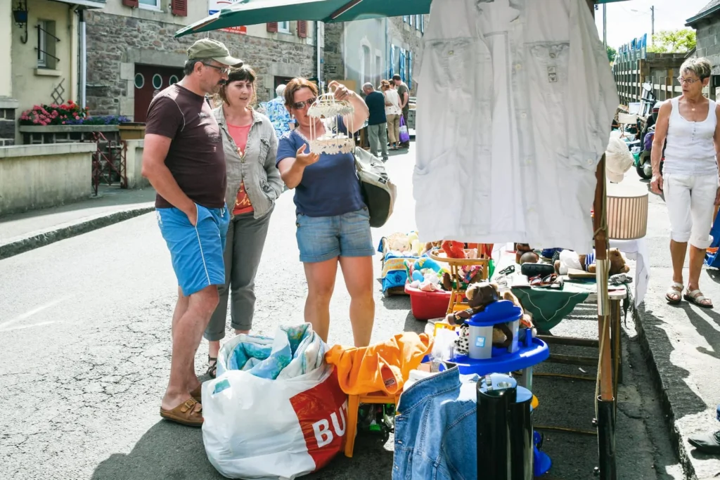 Village street market in the French countryside with locals browsing stalls