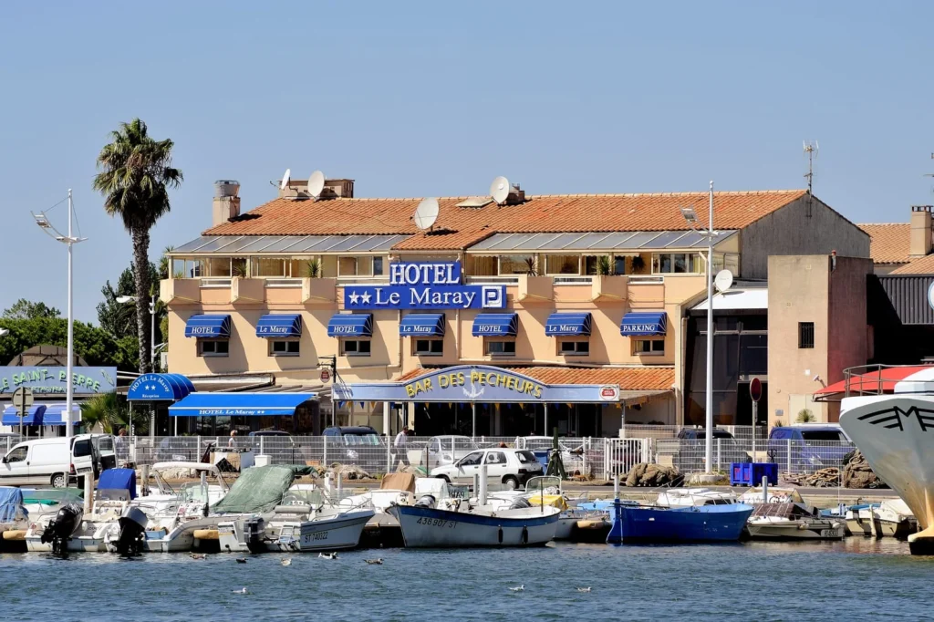Harborfront hotel and fishing boats in Grau-du-Roi, southern France