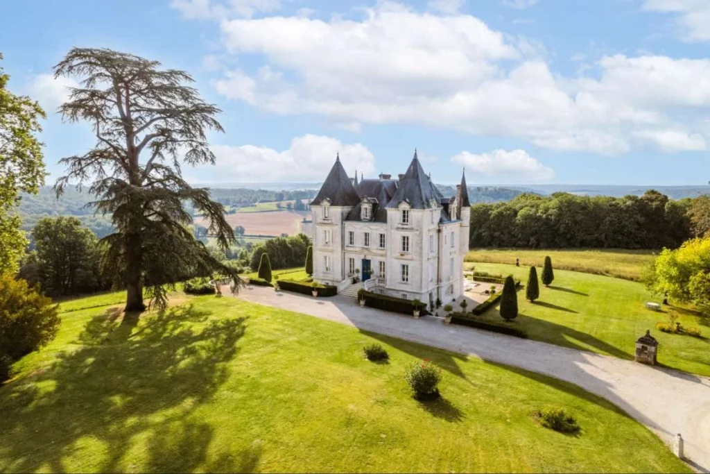 French château surrounded by lawns and countryside views in Dordogne