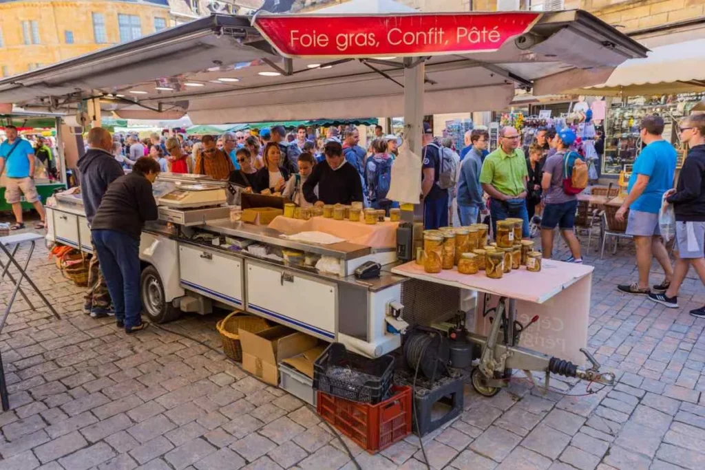 People looking at produce at the famous market at the old medieval town of Sarlat-la-Caneda, Dordogne