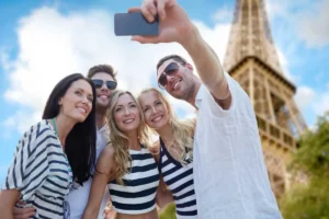 Tourists taking a selfie near the Eiffel Tower in Paris, France
