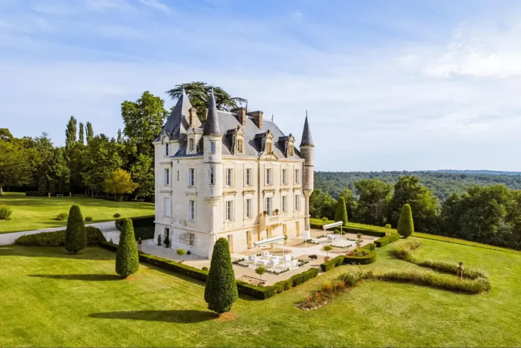 Elegant French château surrounded by manicured gardens and countryside views