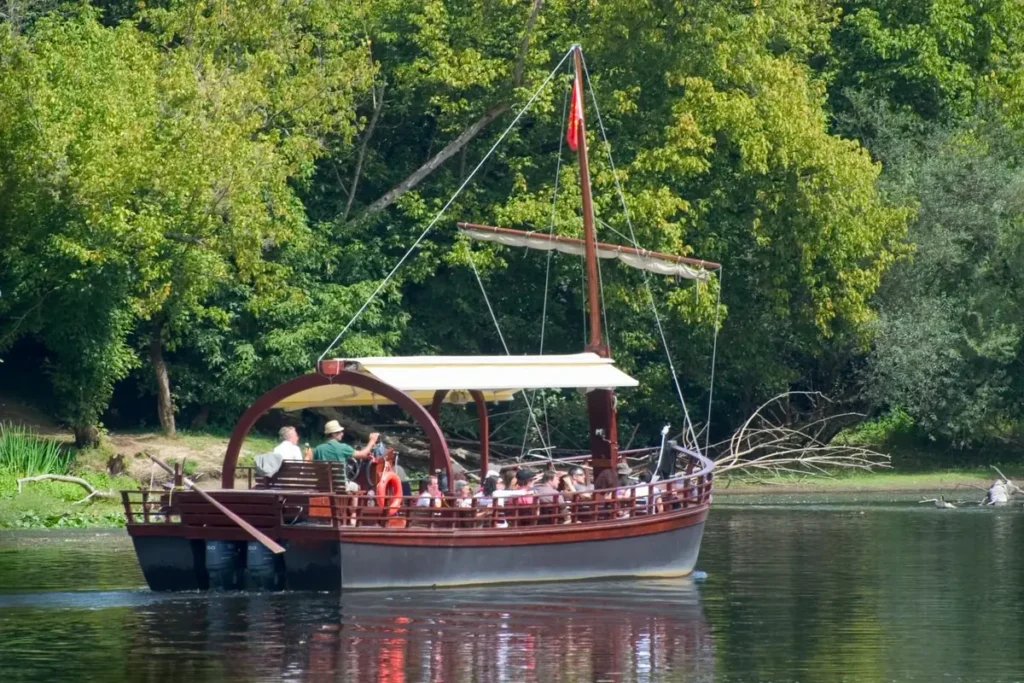 Traditional boat on the Dordogne River surrounded by trees