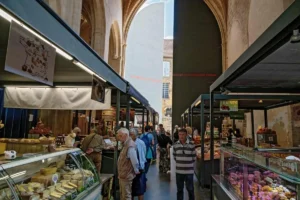 Visitors and stalls in the market hall of Sarlat