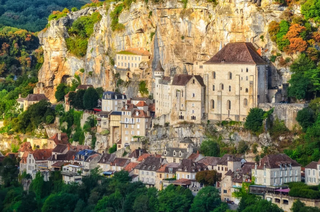 Full view of Rocamadour village built into limestone cliffs with sanctuary and medieval houses