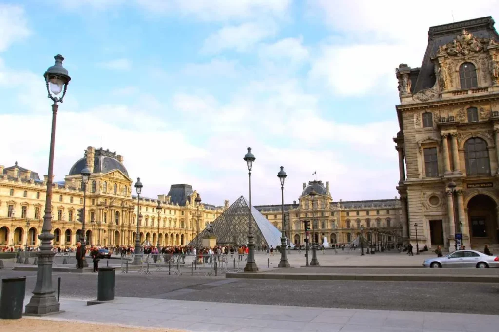 Louvre Museum courtyard with glass pyramid in Paris, France
