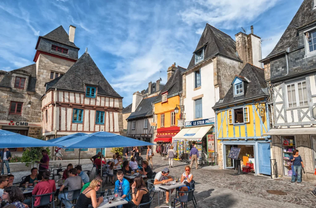 Traditional French town square with outdoor cafes and historic buildings in Brittany