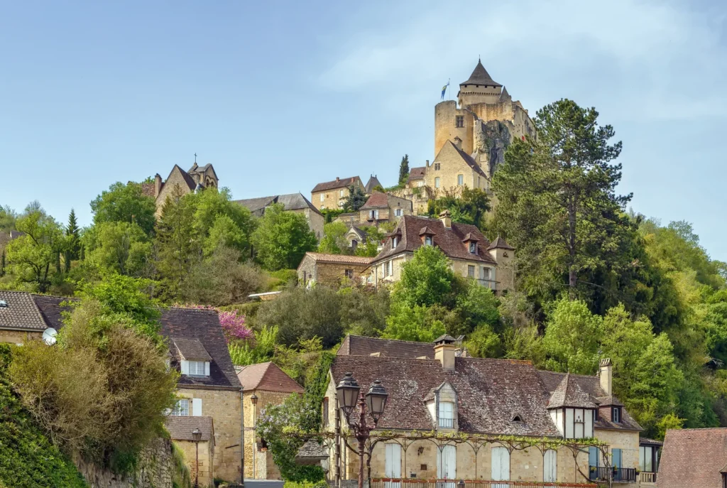 Dordogne hilltop village with historic stone houses and castle overlooking the countryside