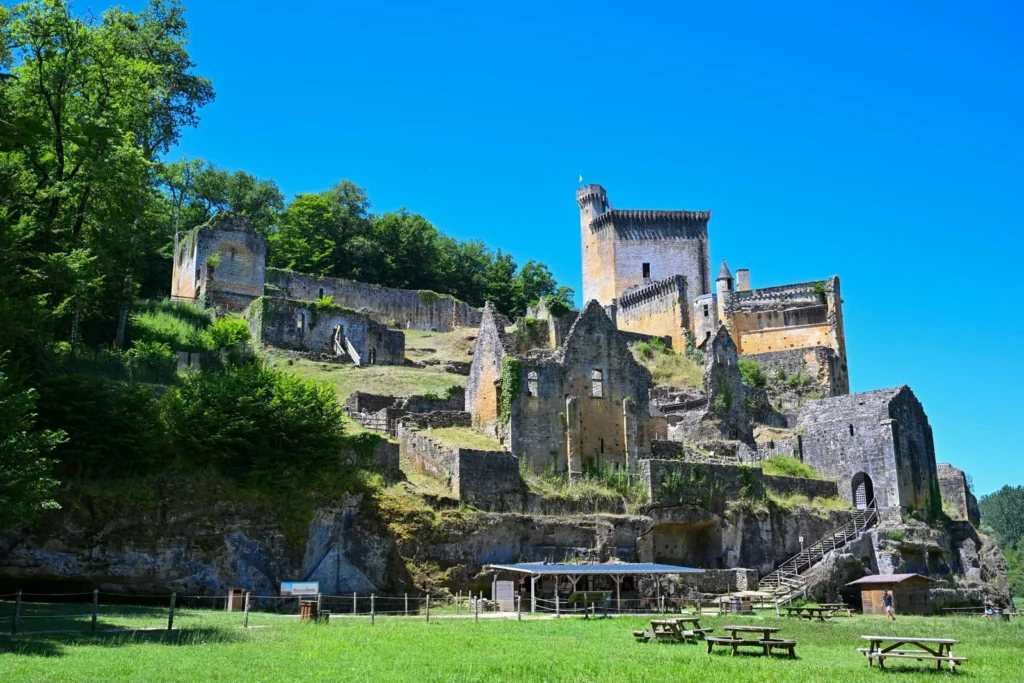 Dordogne castle ruins at Château de Commarque surrounded by forest and open valley landscape