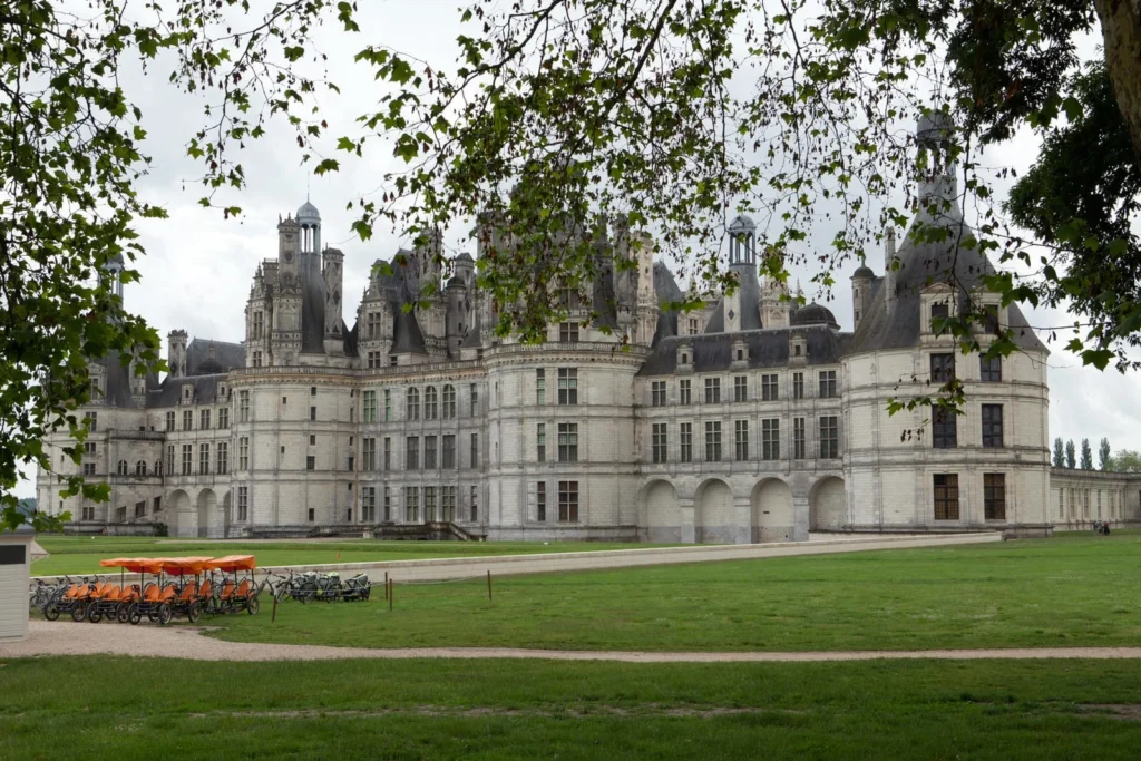 Wide exterior view of Château de Chambord with towers and grand Renaissance architecture