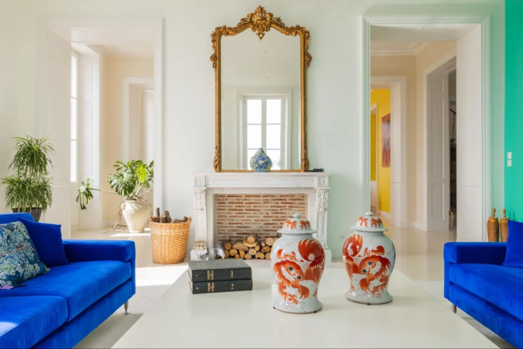 Elegant French chateau living room with blue sofas, fireplace, and classic decor