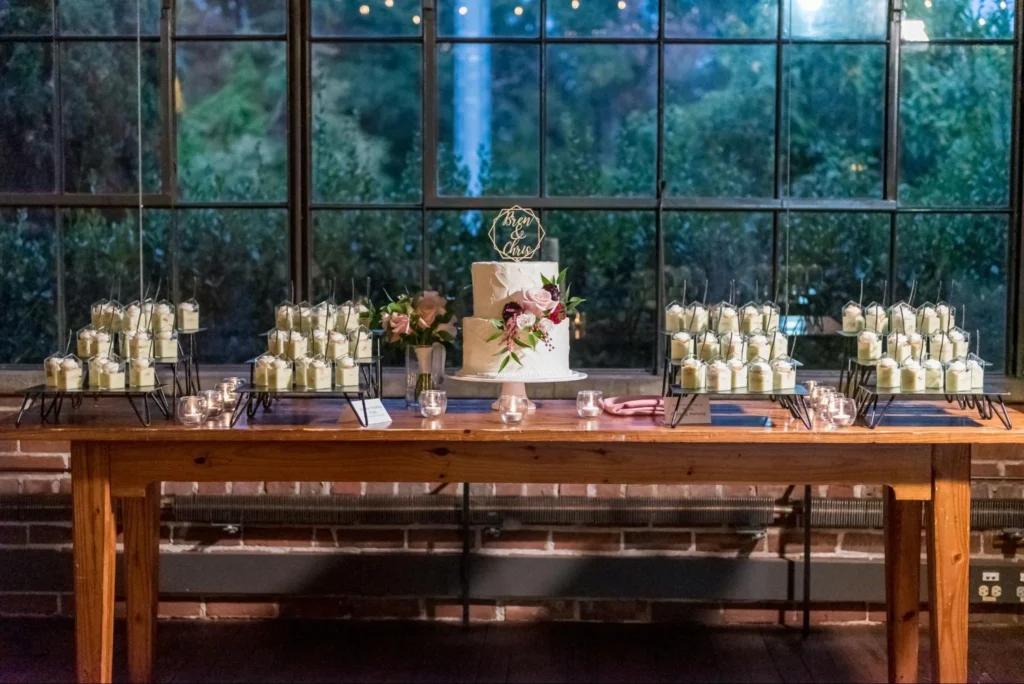 Wedding dessert table with cake, candles, and sweets in chateau venue setting