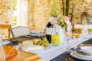 Hotel-style breakfast table with pastries, juice, and a waiter serving drinks in an elegant bedroom setting.