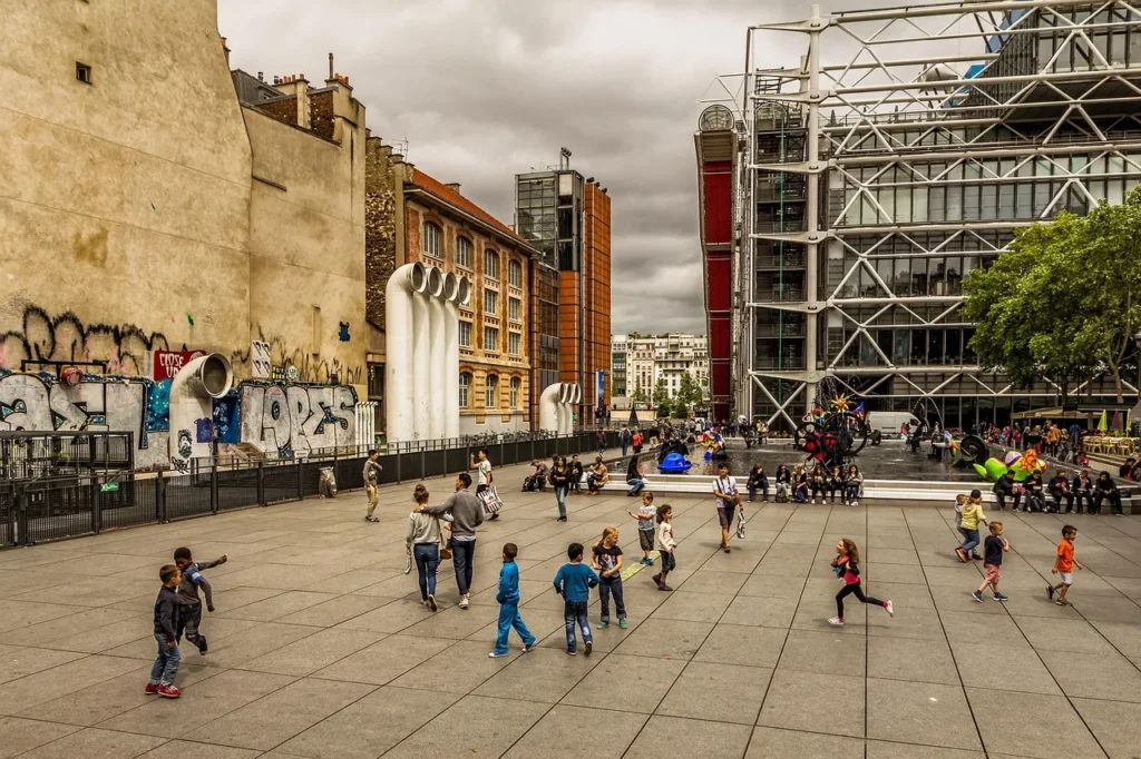 Public square in Paris with families and modern buildings