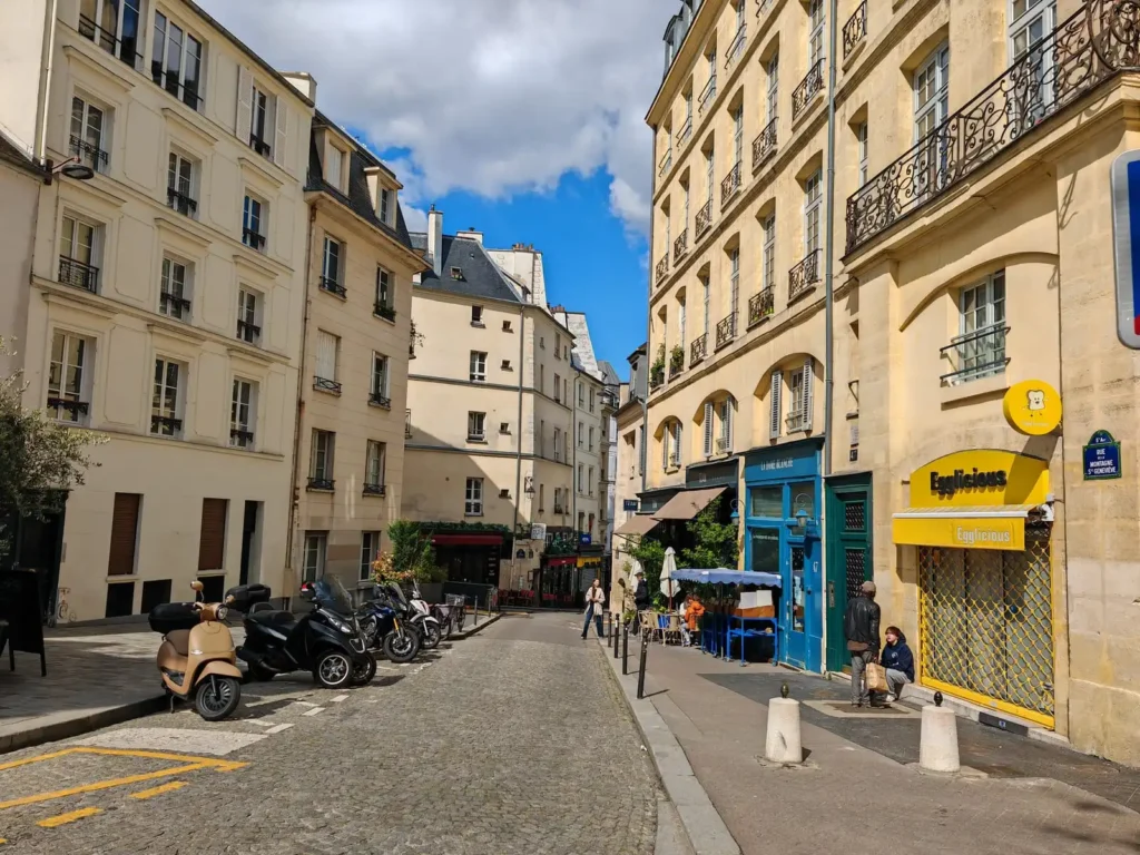 Quiet Paris street with classic buildings and cafés