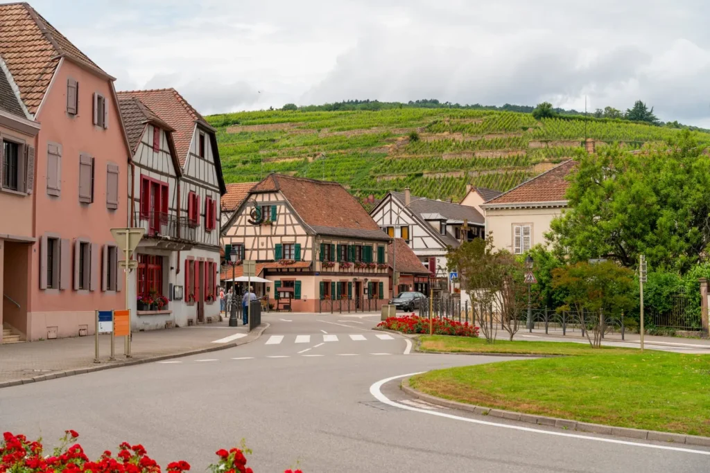 Alsace village street with vineyards in the background