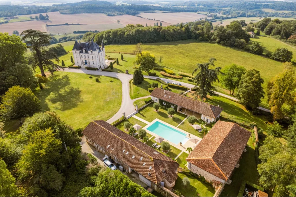 Aerial view of a château estate with pool and gardens