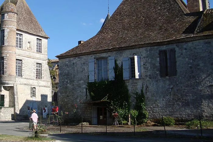 Historic stone building with turret in Issigeac