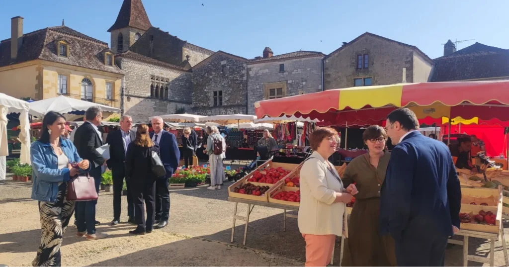 Monpazier market with local stalls and visitors
