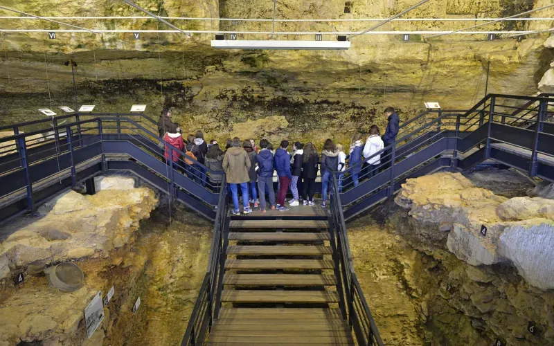 Visitors exploring a prehistoric cave site