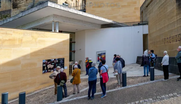 Visitors outside a prehistoric site entrance