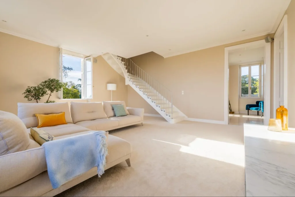Bright living room with modern furniture in a French château