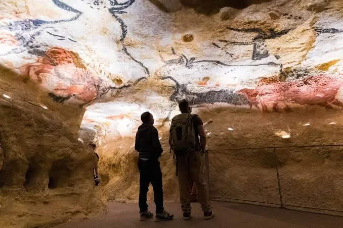 Visitors viewing prehistoric cave paintings at Lascaux