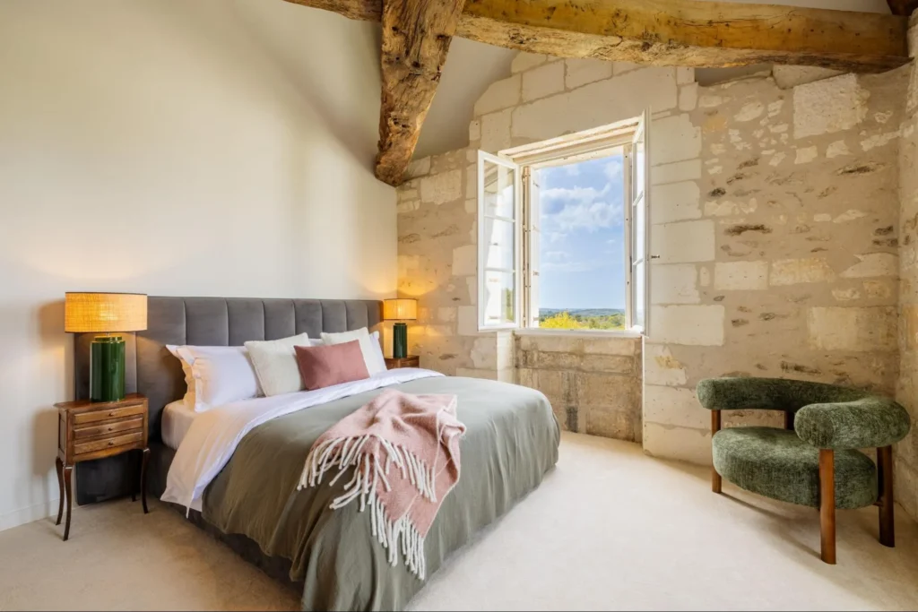 Elegant château bedroom with rustic stone walls