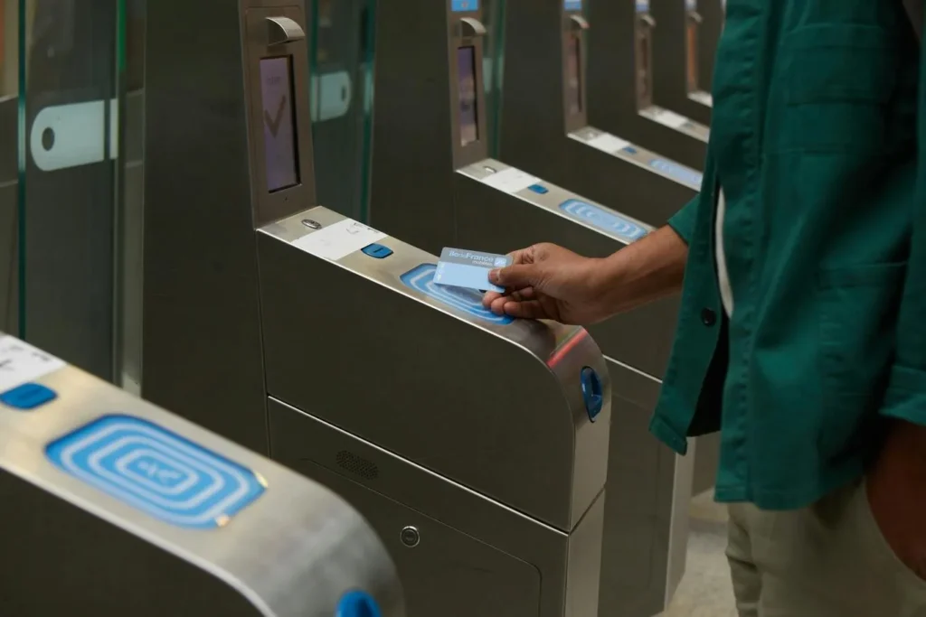 Passenger using a contactless card at Paris Metro gates
