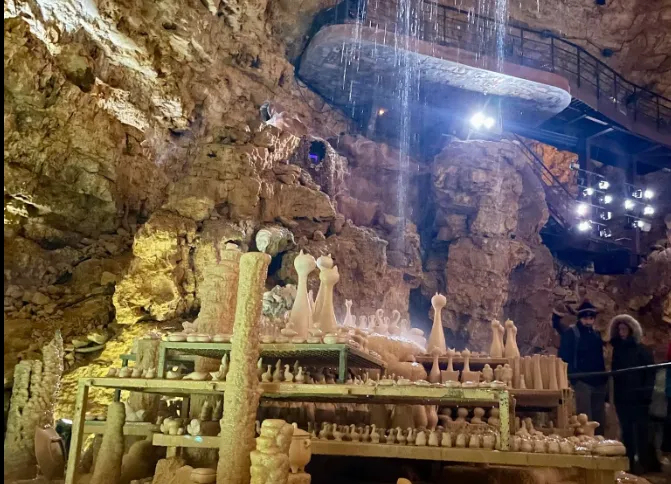 Illuminated mineral formations inside Proumeyssac Cave